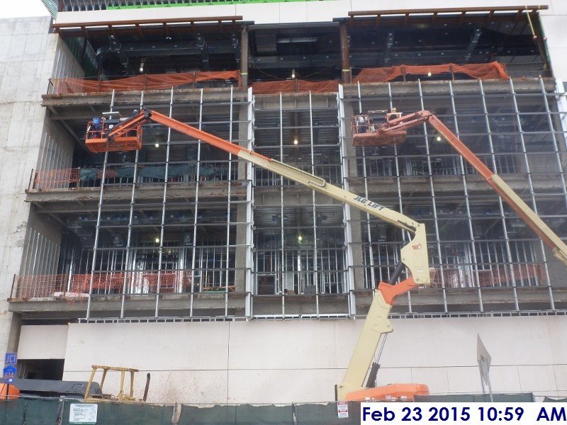 Installing weather strips throughout the Curtain Wall South Elevation